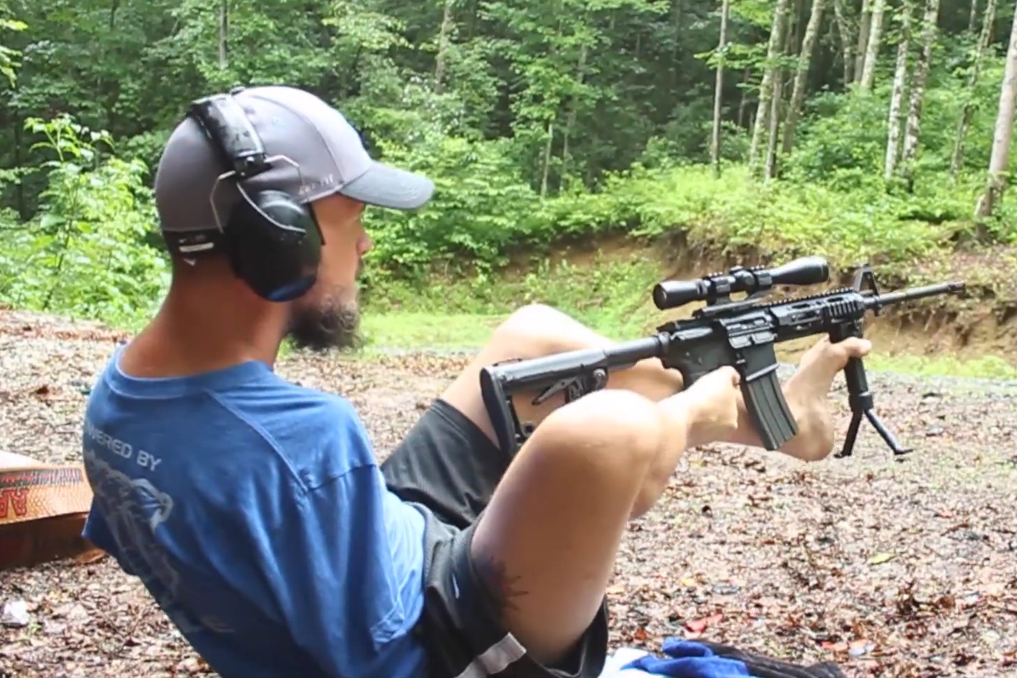 Daniel shooting a rifle with his feet